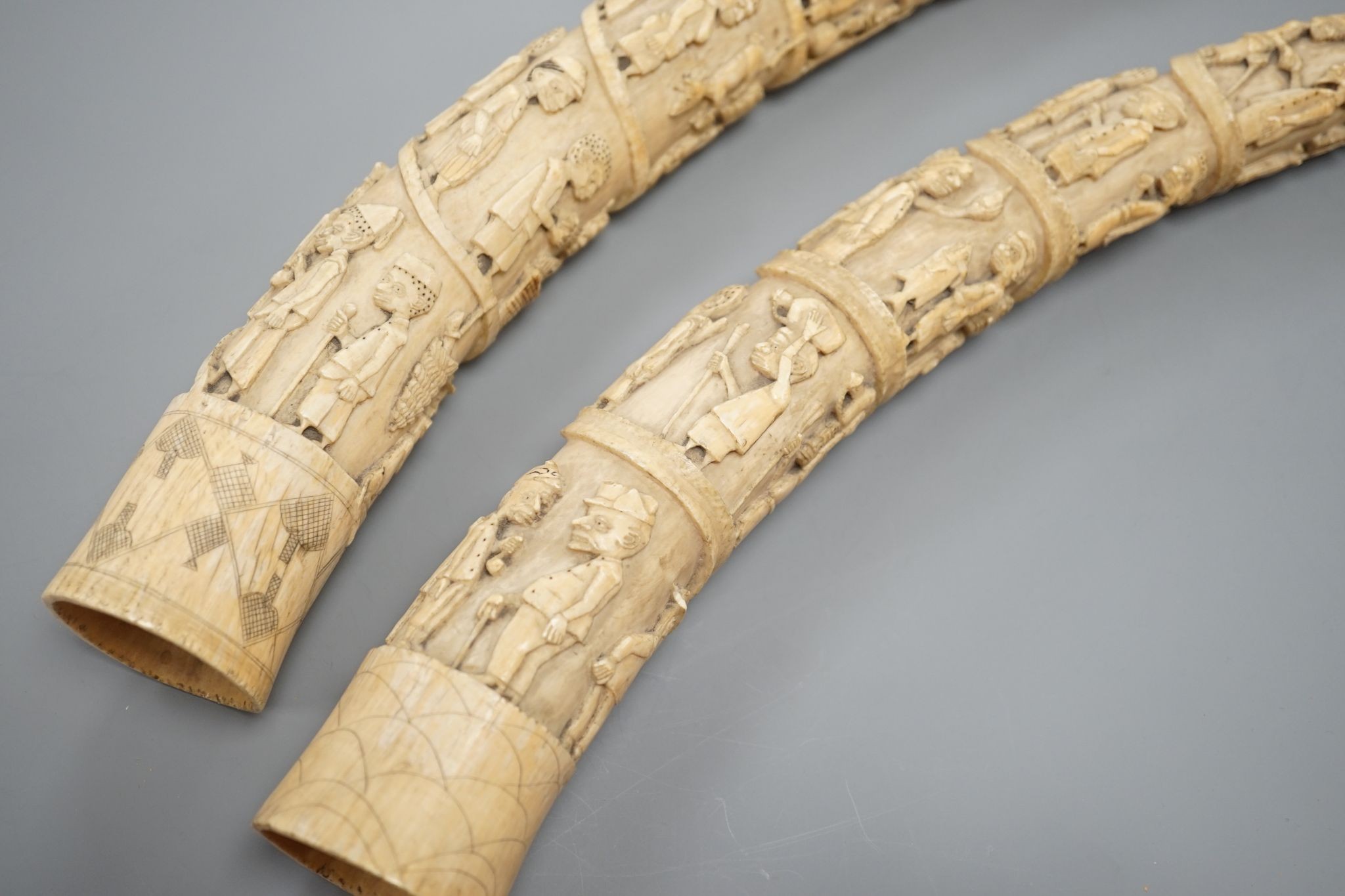 Two Loango carved ivory tusks, Republic of Congo, mid to late 19th century, 46cms long.